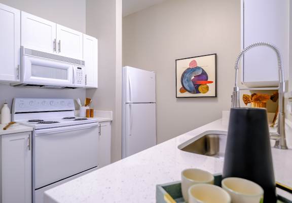 well appointed kitchen with modern white cabinetry at Roosevelt Square apartments in Phoenix