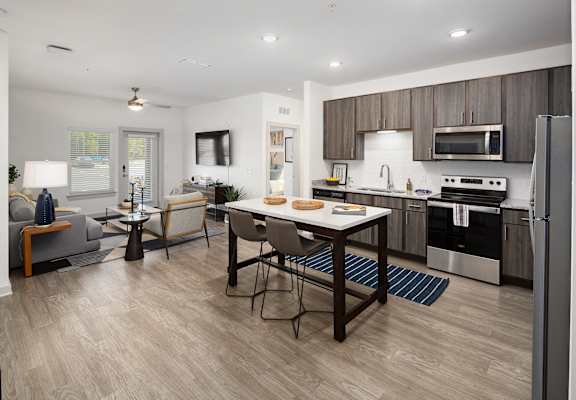 a kitchen and living room with a table and chairs