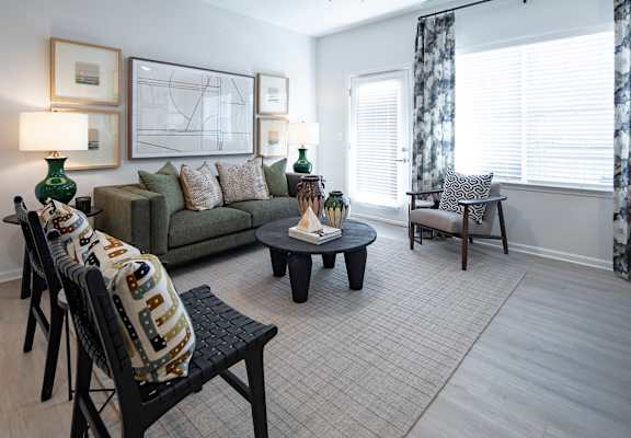 a living room with a couch and chairs and a table