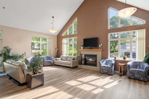a living room with couches and chairs and a fireplace