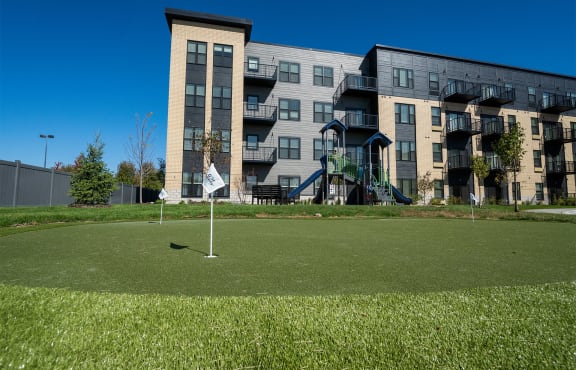 a golf course in front of an apartment building