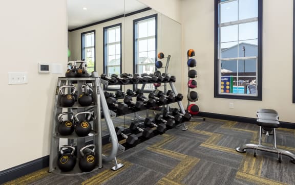 the gym has a wall of dumbbells and exercise equipment at Overland Park, Pickerington, OH