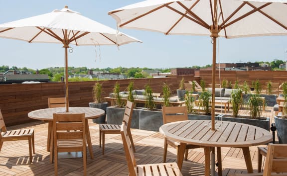 a rooftop patio with tables and chairs and umbrellas  at Iron Works Sono, Norwalk, Connecticut