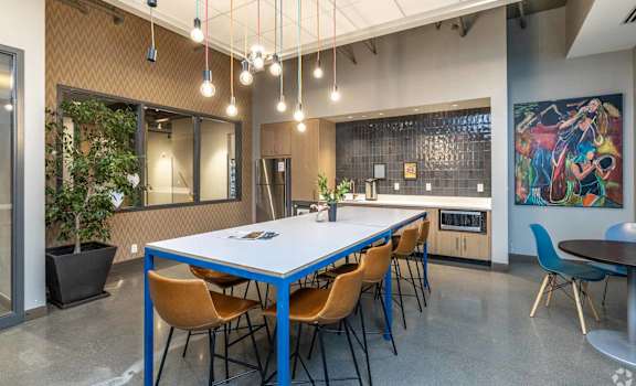 A conference room with a long table and chairs.