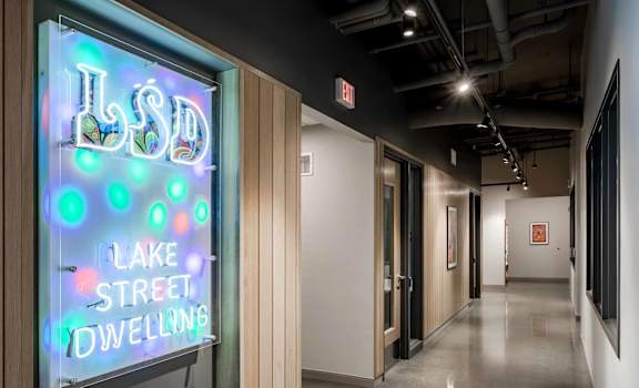 A neon sign that says Lake Street Dwelling.