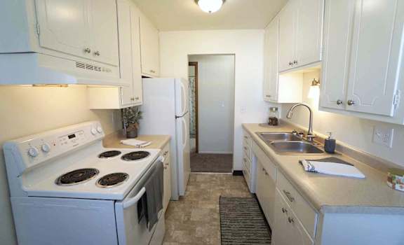 a kitchen with a stove sink and refrigerator