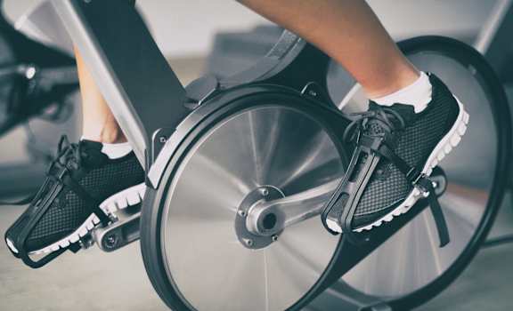 A person is riding an exercise bike.