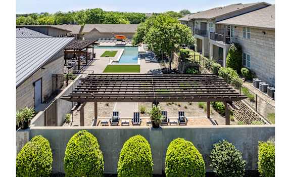 swimming pool and poolside lounging area at The Pradera apartments