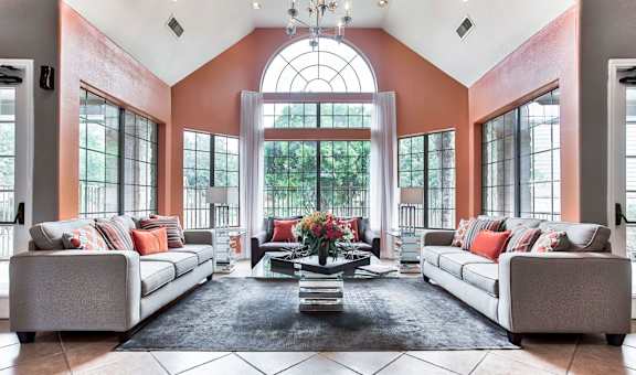 a club house with couches and large windows
