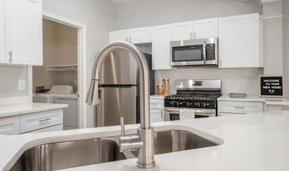Kensington Grove apartments kitchen with white cabinets