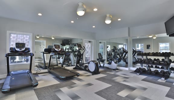 a gym with treadmills and other exercise equipment at Thornblade, Greenville, 29615