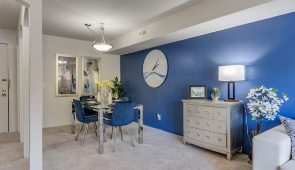 a kitchen with wooden cabinets and a table with a bowl of fruit on it at Willow Creek Apartment, Kalamazoo, MI, 49008