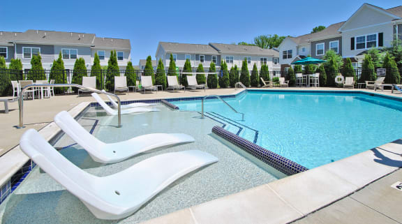 midtown pointe apartments outdoor pool with lounge tanning chairs