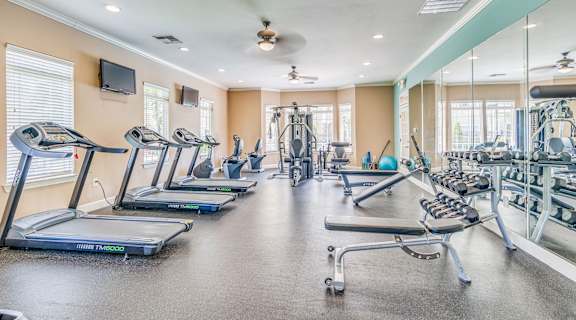 a cardio gym with cardio equipment and windows