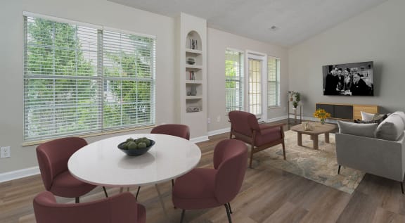 a living room with a table and chairs and a television