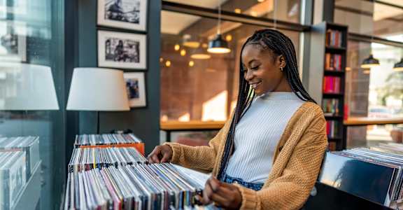 A woman is browsing through a collection of vinyl records.