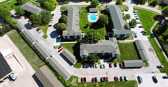 arial view of a house with a pool and parking lot