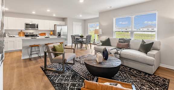 A modern living room with a black coffee table and a white couch.