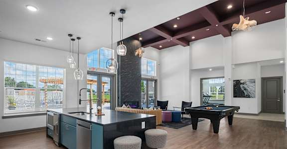 A kitchen with a bar area and a dining table.