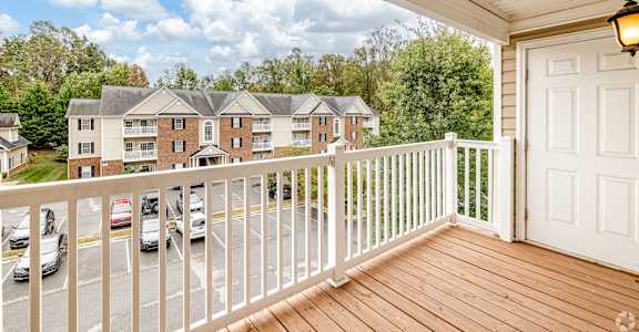 A balcony with a white railing and a white door.