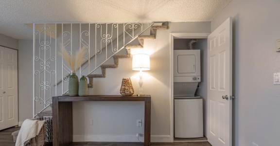 A staircase with a metal railing and a wooden handrail.