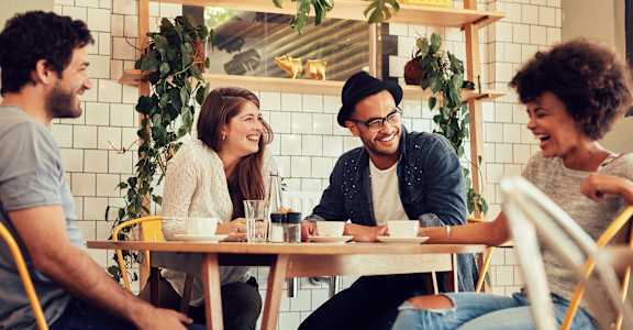 a group of people sitting at a table in a restaurant