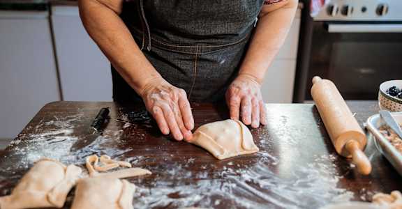a person making cookies on a counter in a kitchen