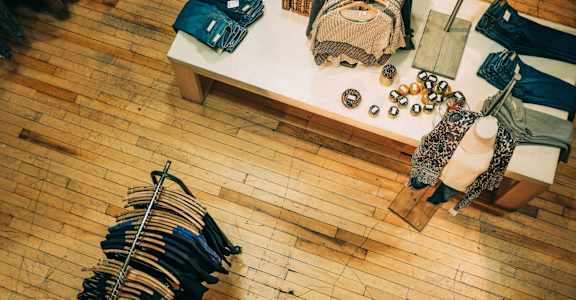 a display of clothes and bags on a table in a store