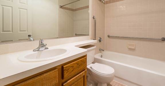 A bathroom with a white sink and a white toilet.