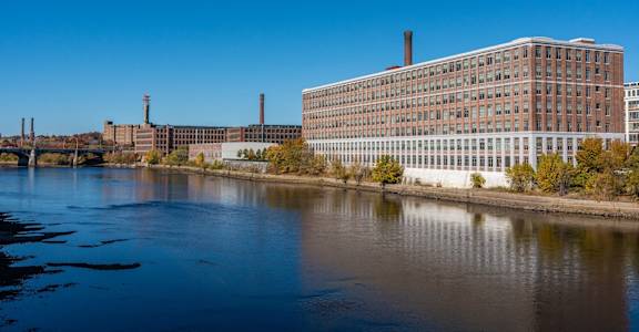 a view of a river in front of a large building