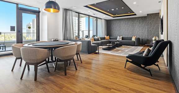 A modern living room with a large table and chairs.