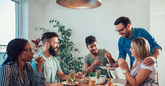 a group of people sitting around a table eating food