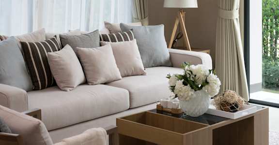 a living room with a white couch and a coffee table