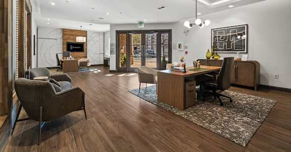 A modern office with wood floors and furniture. at 1010 Dilworth Apartments, Charlotte, North Carolina