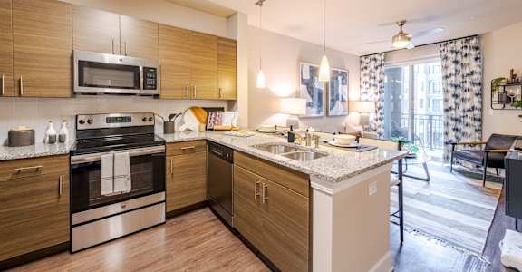 A modern kitchen with wooden cabinets and stainless steel appliances