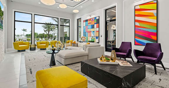 a living room with yellow furniture and large windows at Altis Grand Kendall, Florida, 33186
