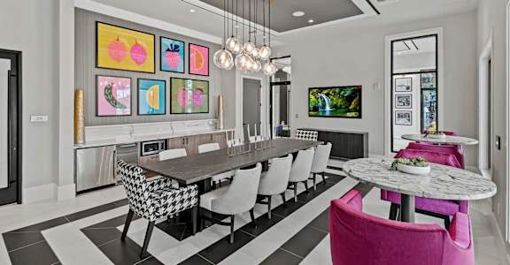 a dining room with a long table and chairs at Altis Grand Kendall, Florida, 33186