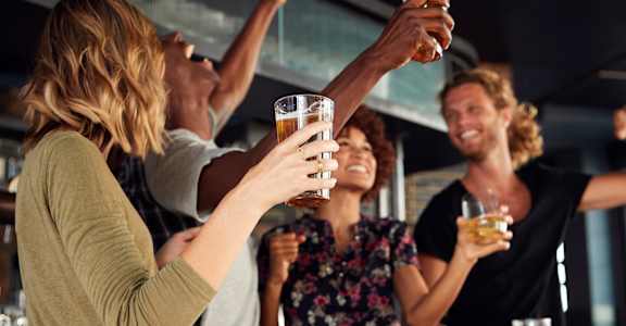 a group of people drinking beer in a bar
