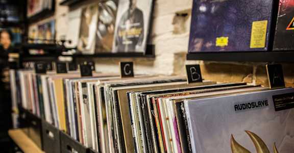 a row of vinyl records on a shelf
