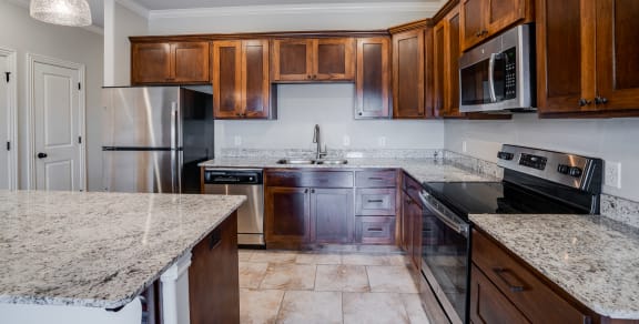 Kitchen Featuring Tile-Style Flooring With Lots Of Cabinetry