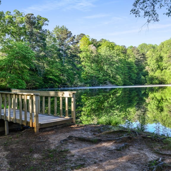 a dock on a lake with trees in the background