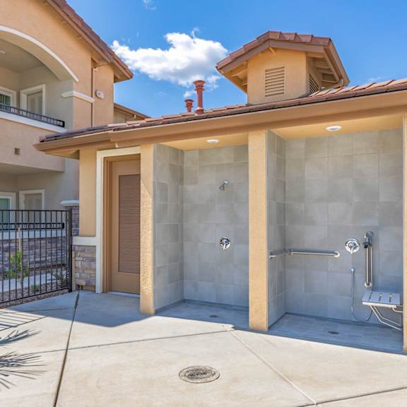 a walk in shower in front of a house with a patio  at Heritage Landing Apartments, Chico, 95973
