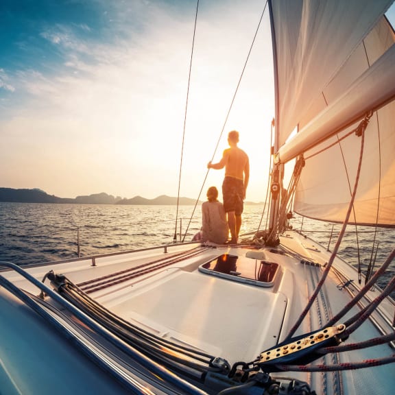 people on a boat at sunset