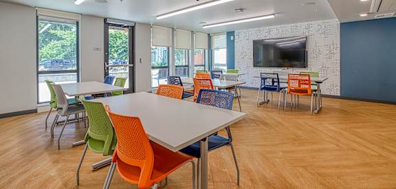 A conference room with a long table and chairs.