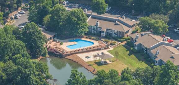 an aerial view of a backyard with a swimming pool and houses at Arbor Ridge, Greensboro