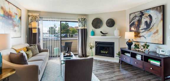 Living Room with Patio and Fireplace at Deer Crest Apartments, 80020