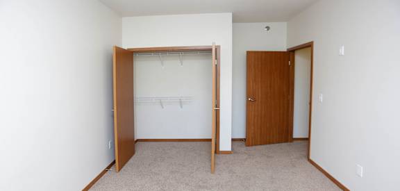 a bedroom with a closet and an open door