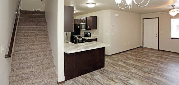 a view of the living room and kitchen from the stairs