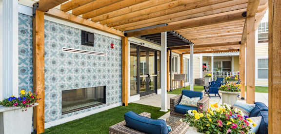 a patio with a fireplace and a wooden roof
