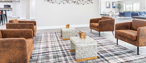a living room with couches and chairs and a rug